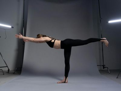 Person doing side stretch in a bright studio
