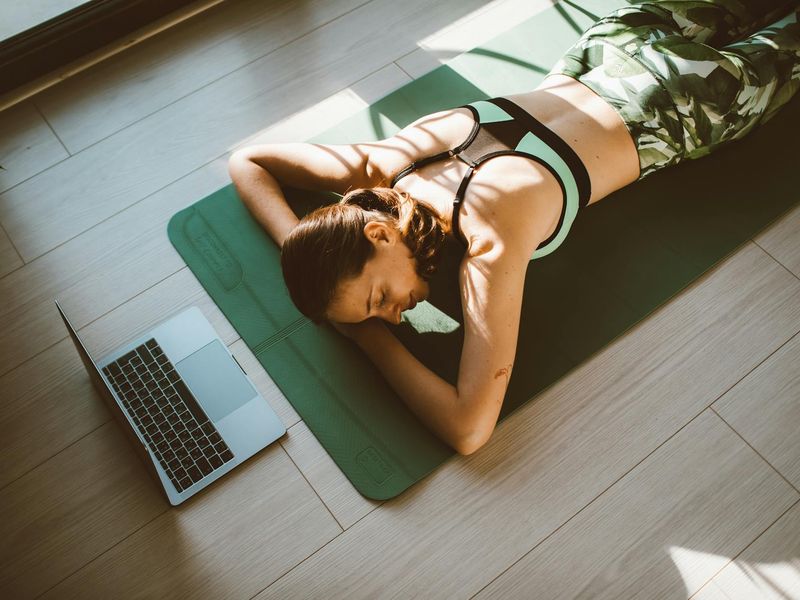 Yoga mat lying in a sunlit minimal studio room